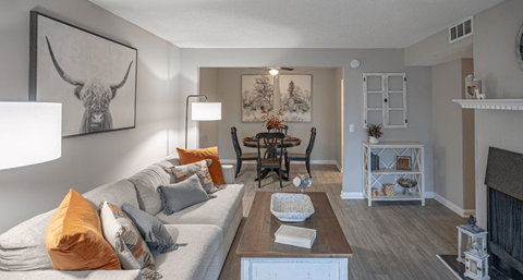 a living room and dining room with a couch and a table